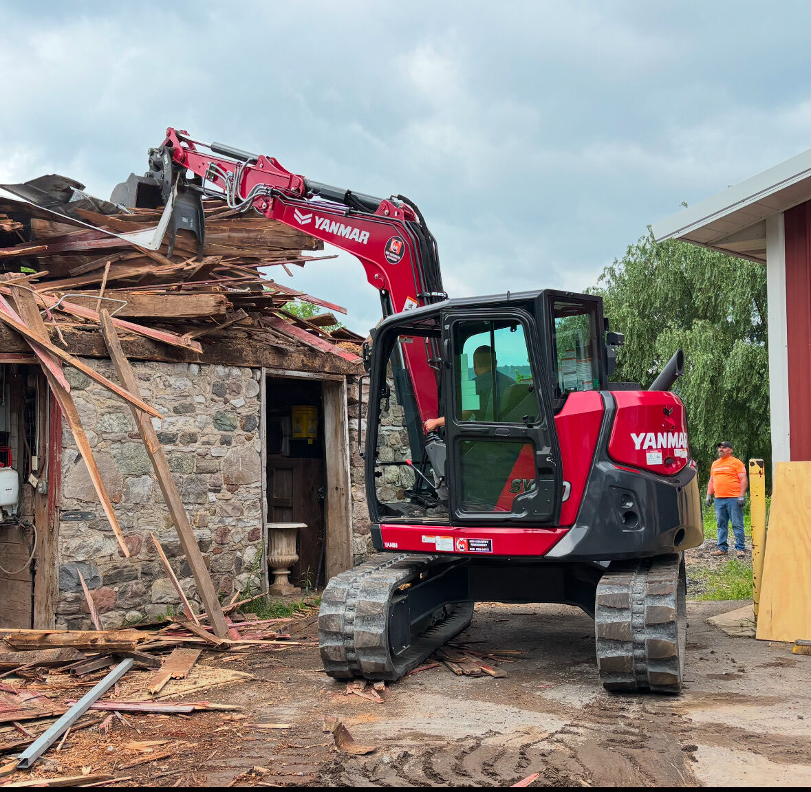 Excavator taking down a stone building in Central New York